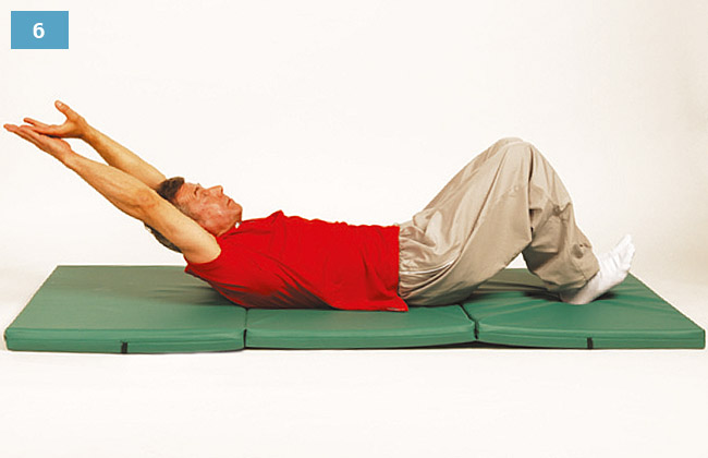 Ćwiczenie w leżeniu na plecach, głowa uniesiona, ręce splecione nad głową, pięty oparte na materacu